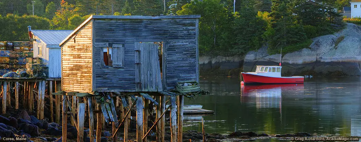 Red lobster boat next to lobster shack