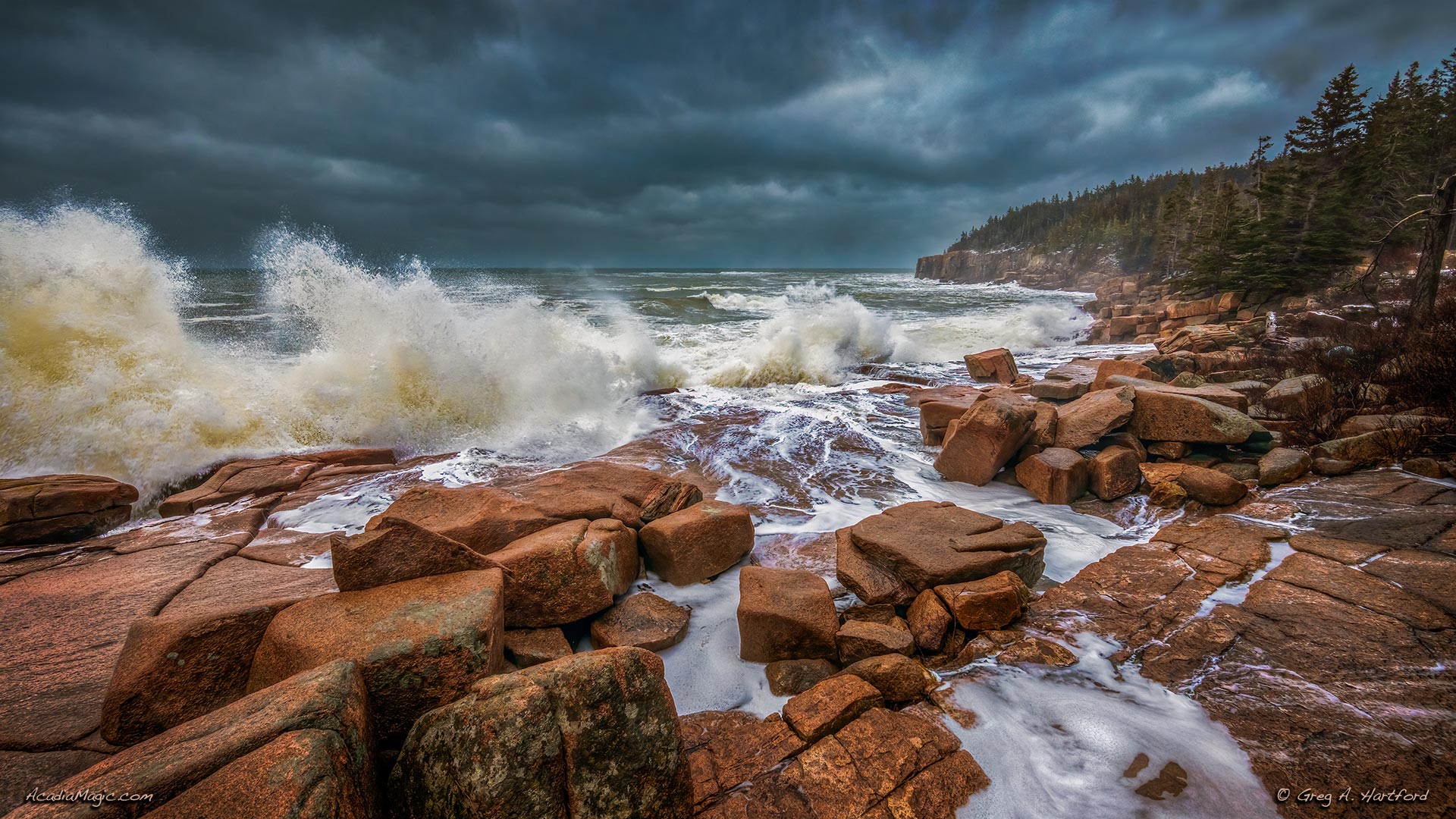 Otter Cliff and crashing waves in Acadia National Park during a winter storm