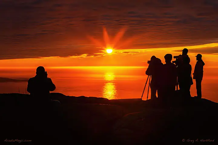 Photographers gather to capture the sunrise from Cadillac Mountain in Acadia.