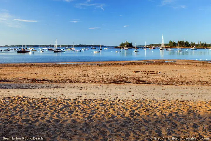 Public beach with view of yachts