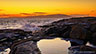 The sun had set behind Cadillac Mountain in the distance as I stood next to the tide pool in the foreground at Schoodic Point in Acadia.