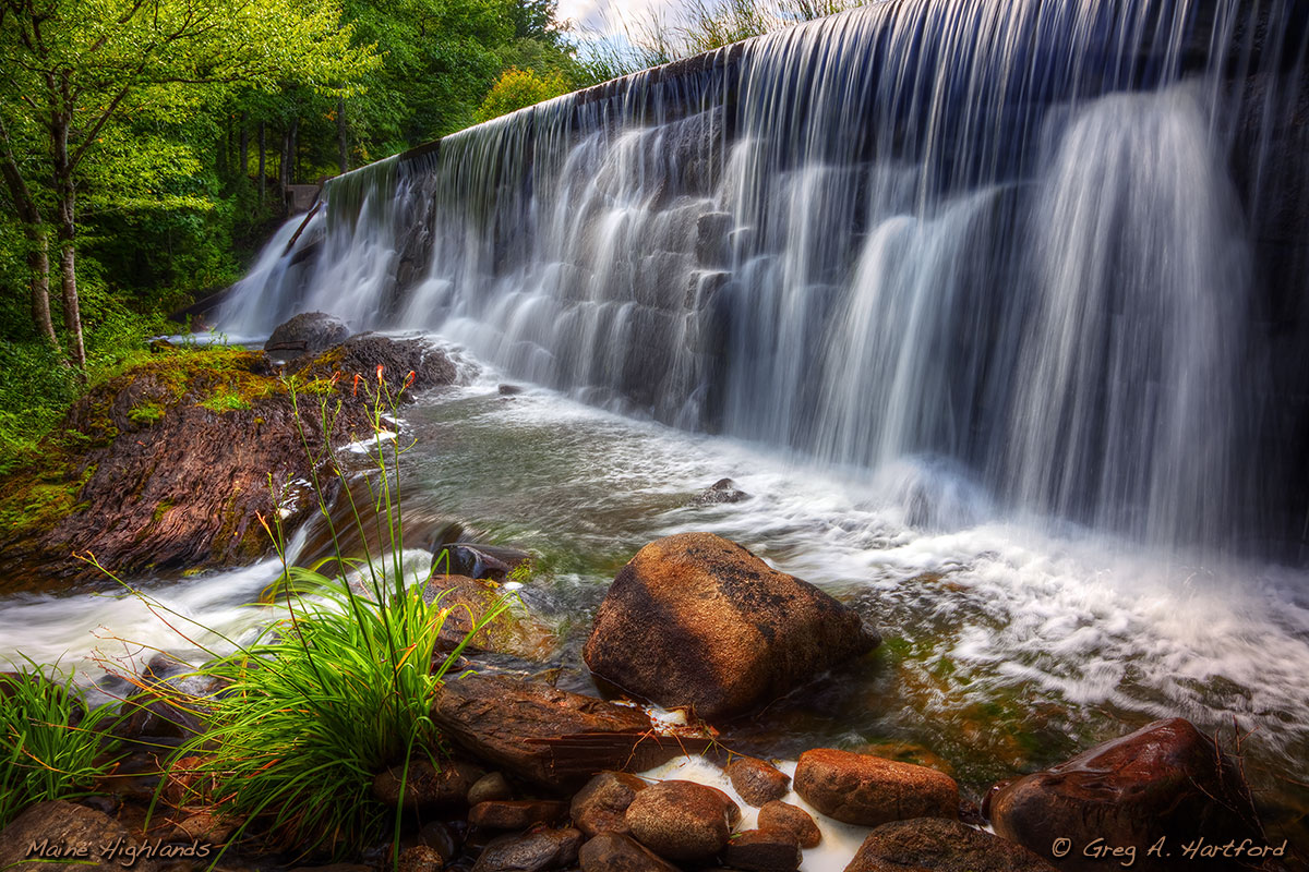 This shows the waterfall at the dam on Garland Pond, in Garland, Maine, in Penobscot County.