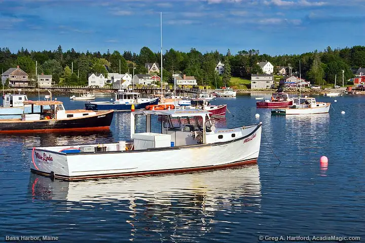 View photo of Maine lobster boat, lobster traps, and view of Bass Harbor, Maine.