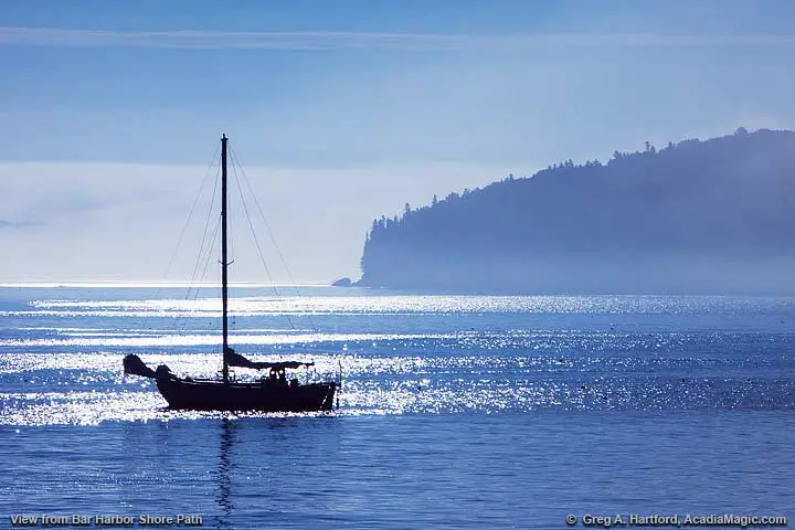 A sailing yacht moored in sparkling ocean water